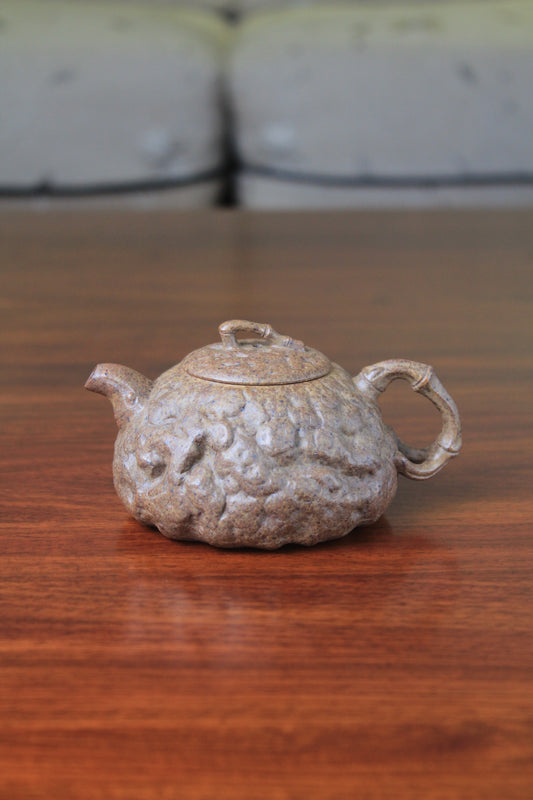 yixing teapot gong chun fully handmade with purple clay on the table