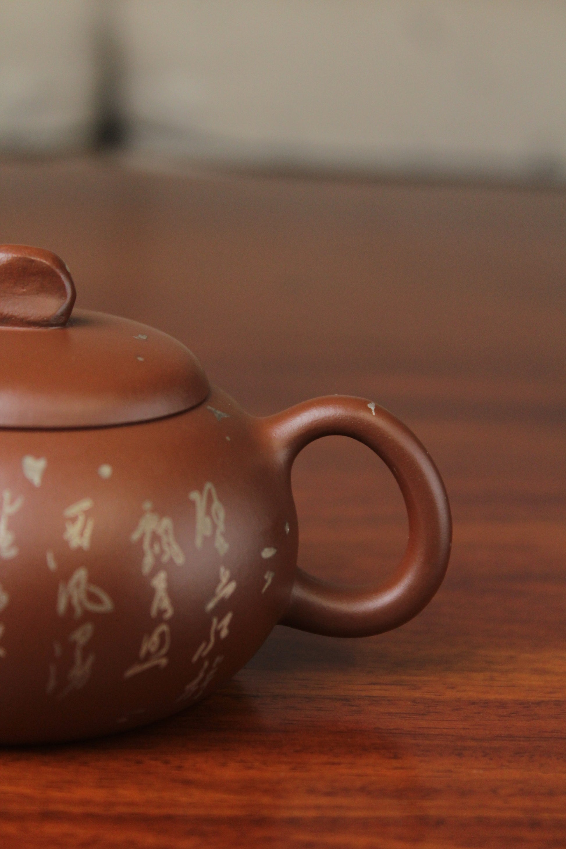 Handle of the yixing teapot on the table