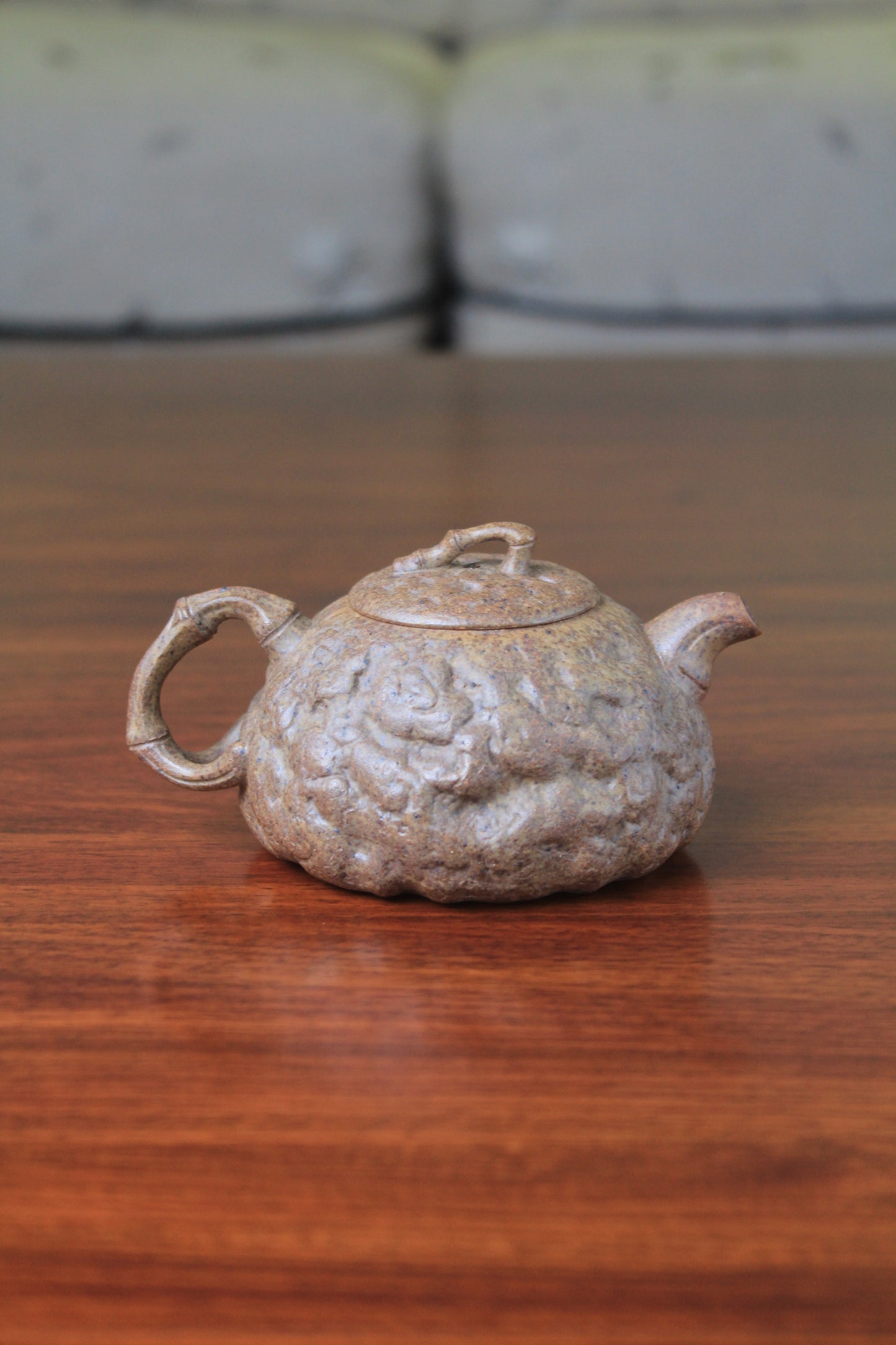 back of yixing teapot gong chun fully handmade with purple clay on the table