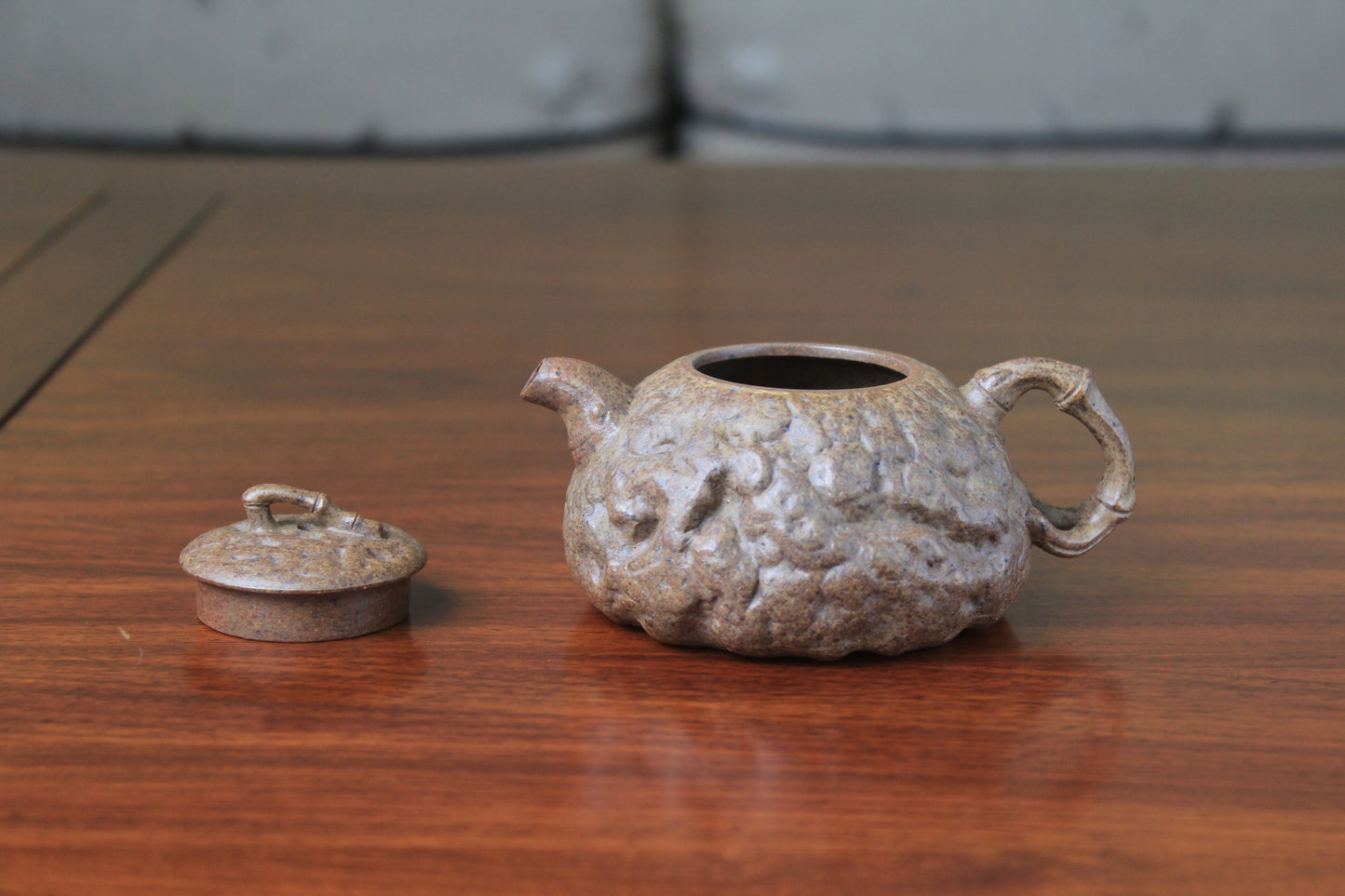 the front of yixing teapot gong chun fully handmade with purple clay on the table