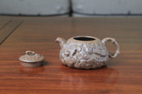 the front of yixing teapot gong chun fully handmade with purple clay on the table