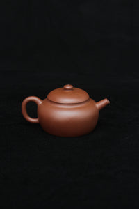 Back of a vintage small Yixing teapot made of dicaoqing purple clay