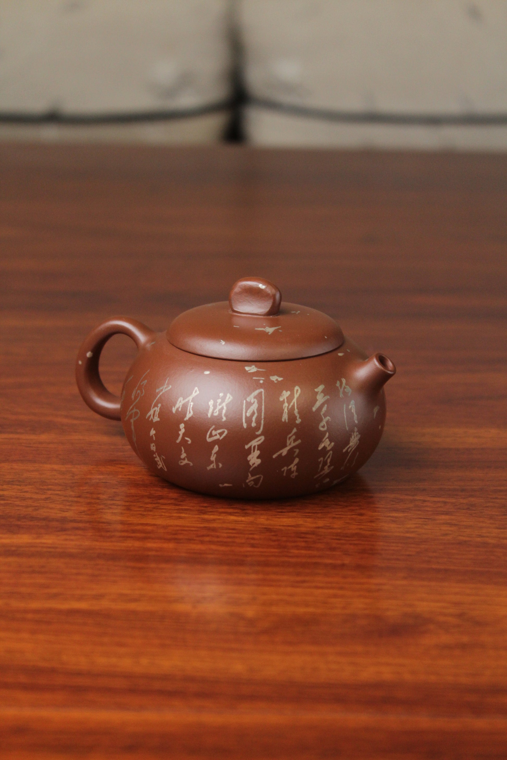 right of the yixing teapot on the table