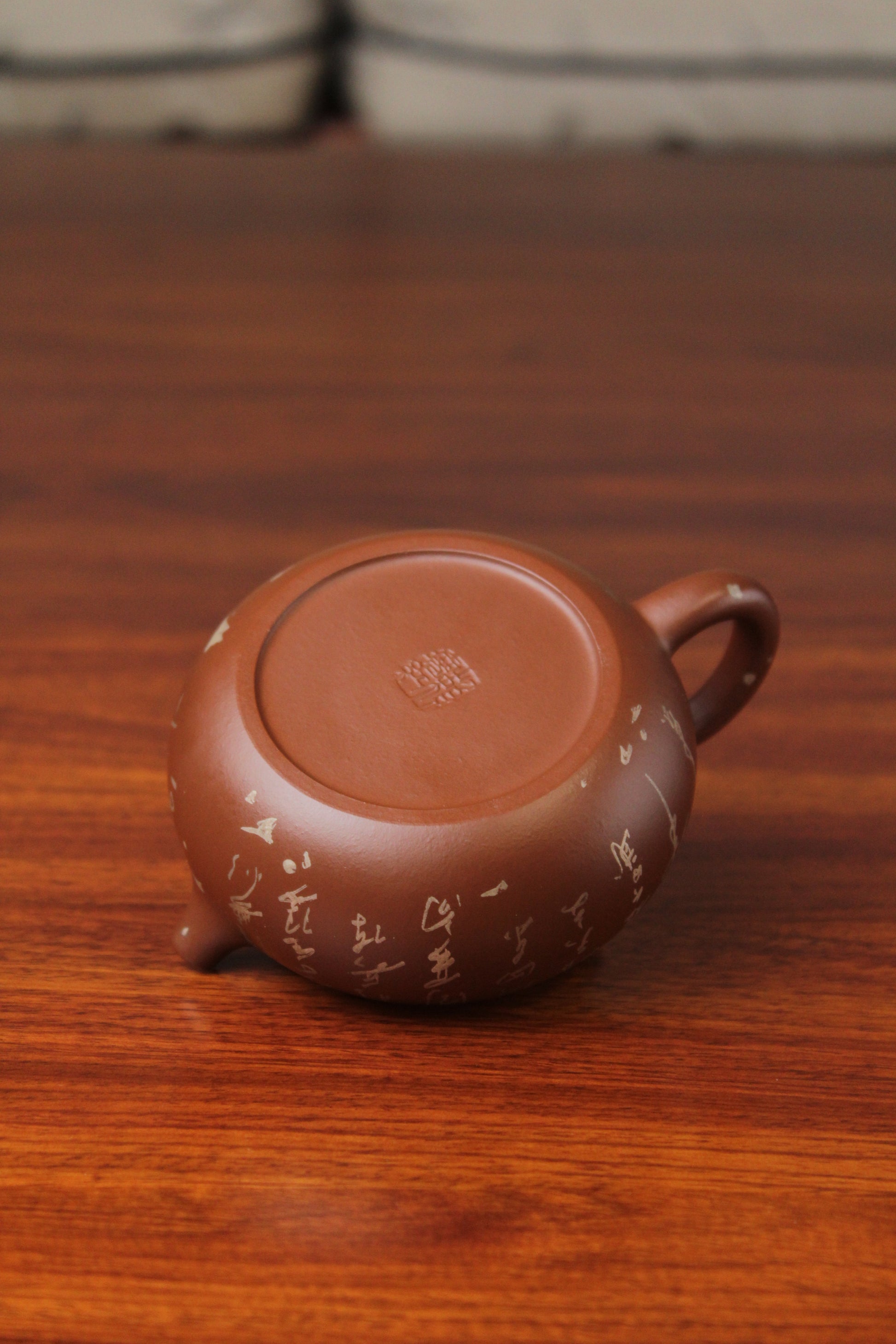 bottom of the yixing teapot on the table