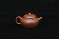 Back detail of a vintage small Yixing teapot made of dicaoqing purple clay