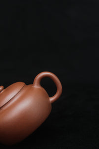 Handle of a vintage small Yixing teapot made of dicaoqing purple clay