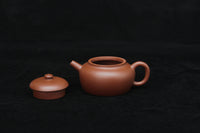 Detail of a vintage small Yixing teapot made of dicaoqing purple clay