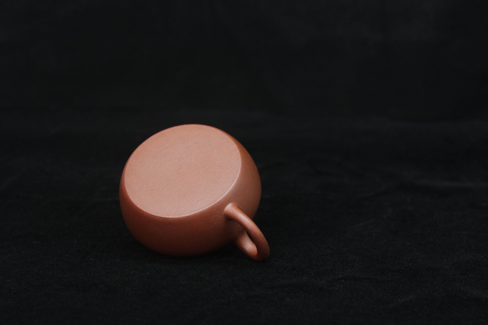 Bottom of a vintage small Yixing teapot made of dicaoqing purple clay.