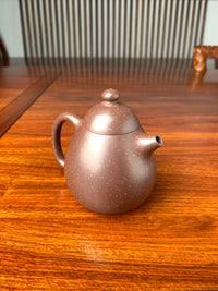 the left view of the yixing teapot on the table