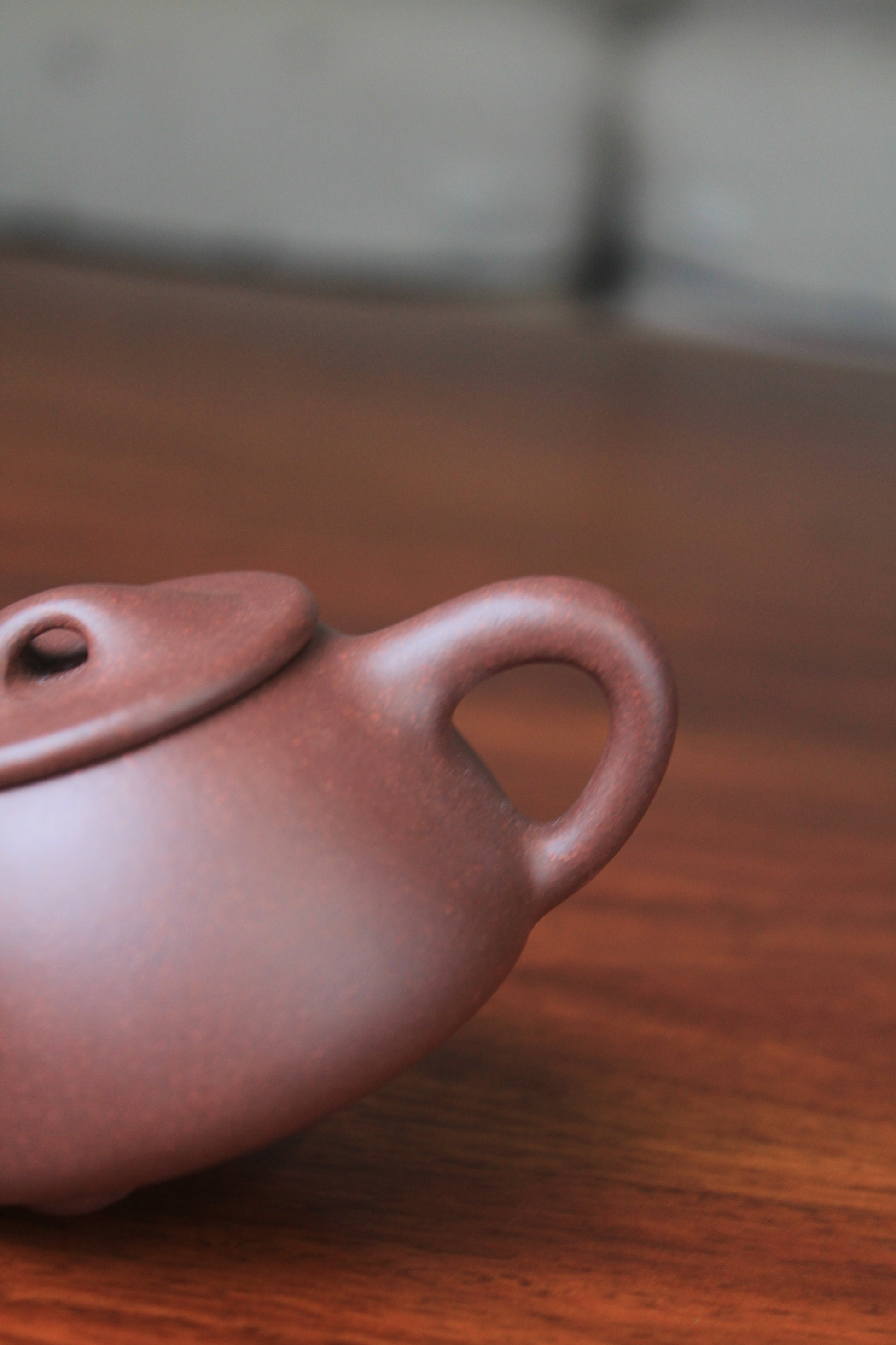 Handle of the Collectible teapot from yixing on the table