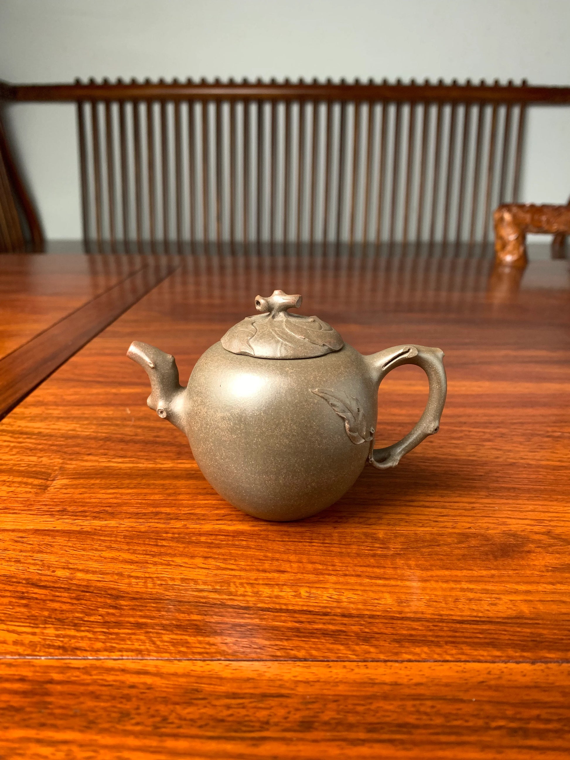 yixing teapot handmade on the table is made with Qing Duanni clay