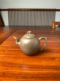 yixing teapot handmade on the table is made with Qing Duanni clay