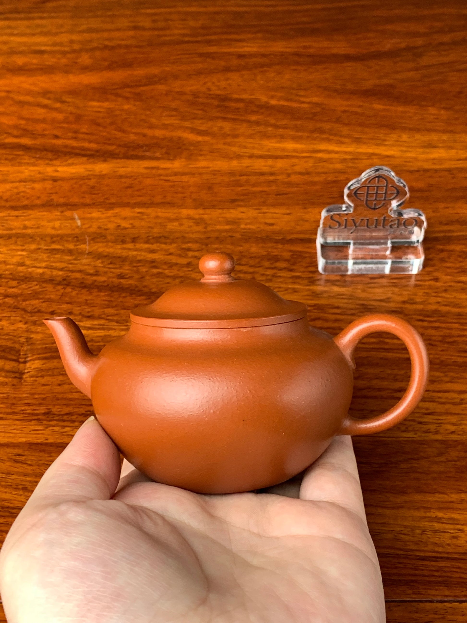 We hold the teapot in hand and find it has a beautiful form