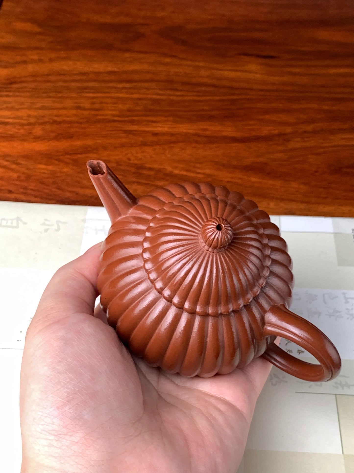 We hold the teapot in our hands to check its quality