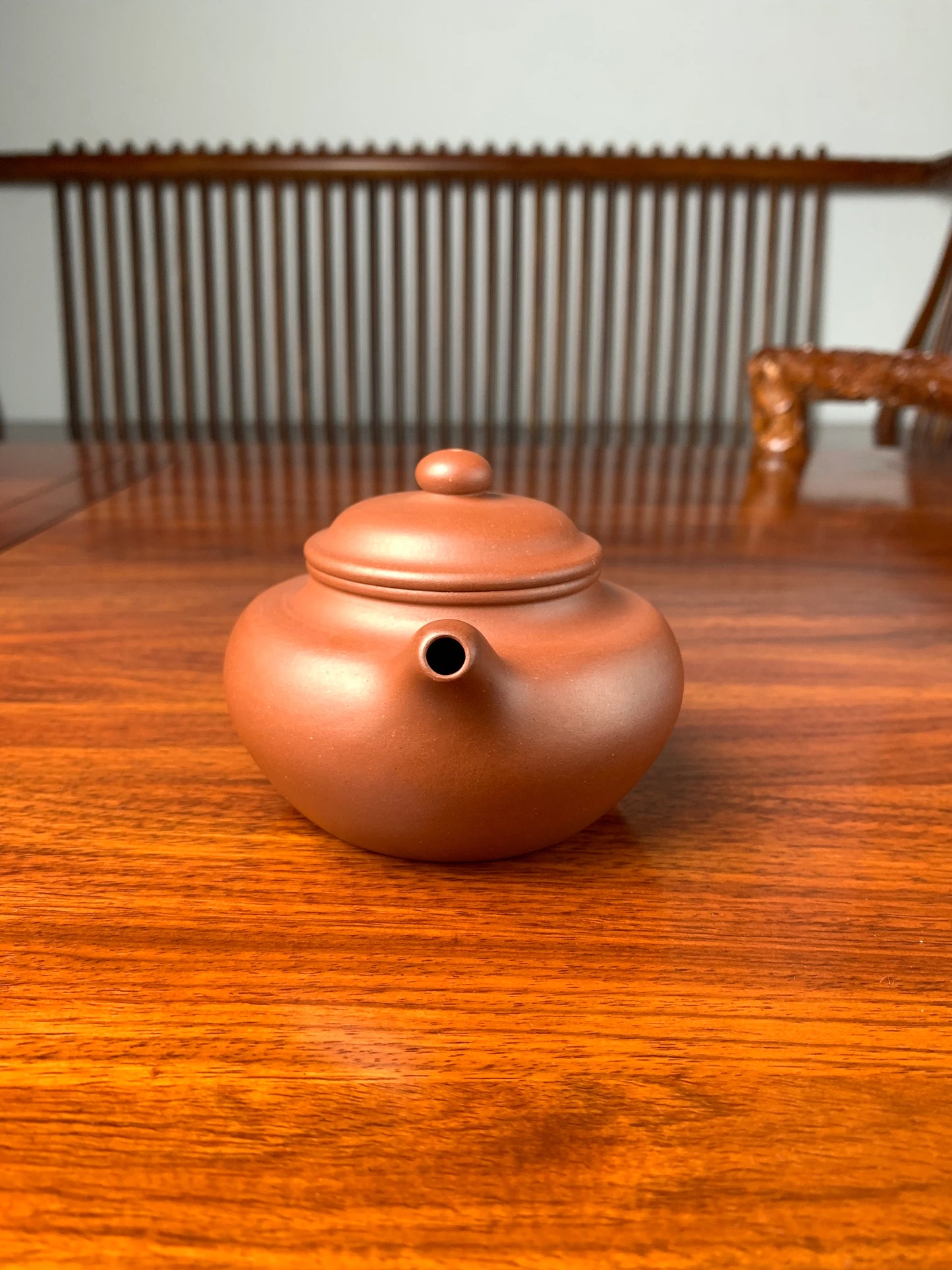 handmade yixing teapot named fang gu on the table front view