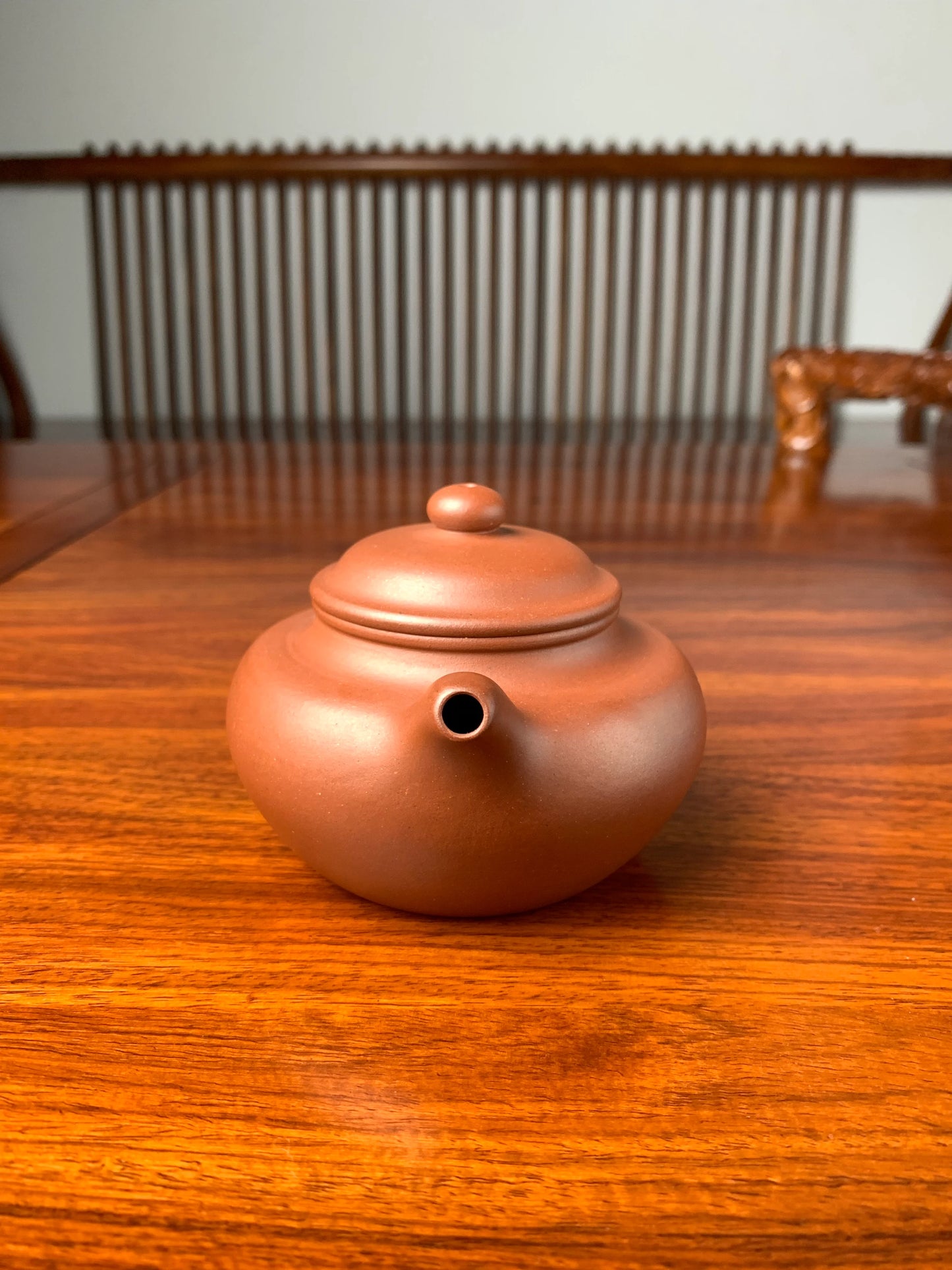 handmade yixing teapot named fang gu on the table front view