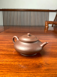 handmade yixing teapot named xu bian on the table left view