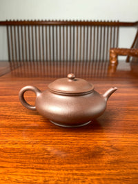 handmade yixing teapot named xu bian on the table back view