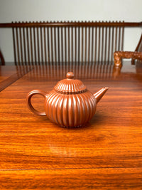the back view of the handmade yixing teapot named shui ping