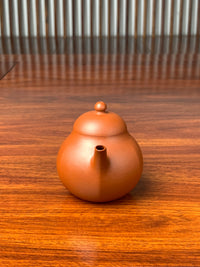 handmade yixing teapot named liu he on the table front view