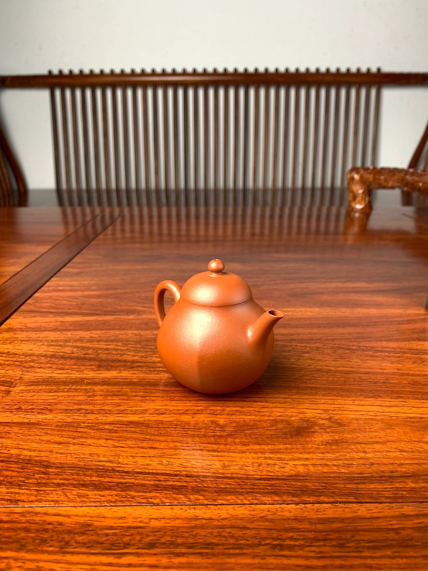 handmade yixing teapot named liu he on the table left view