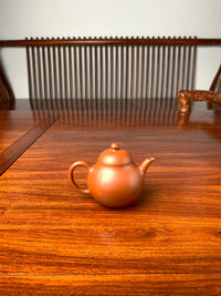 handmade yixing teapot named liu he on the table back view