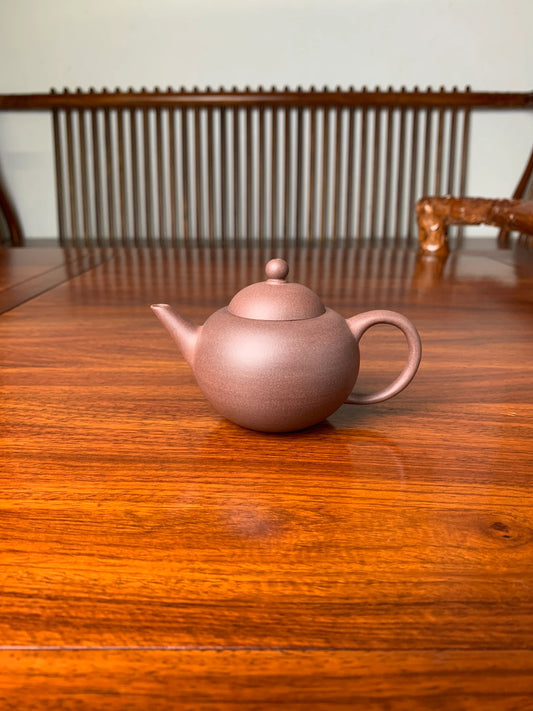 yixing zisha clay teapot qian gai shui ping on the table