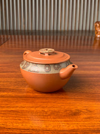 the left view of the yixing zisha clay teapot named bring wealth