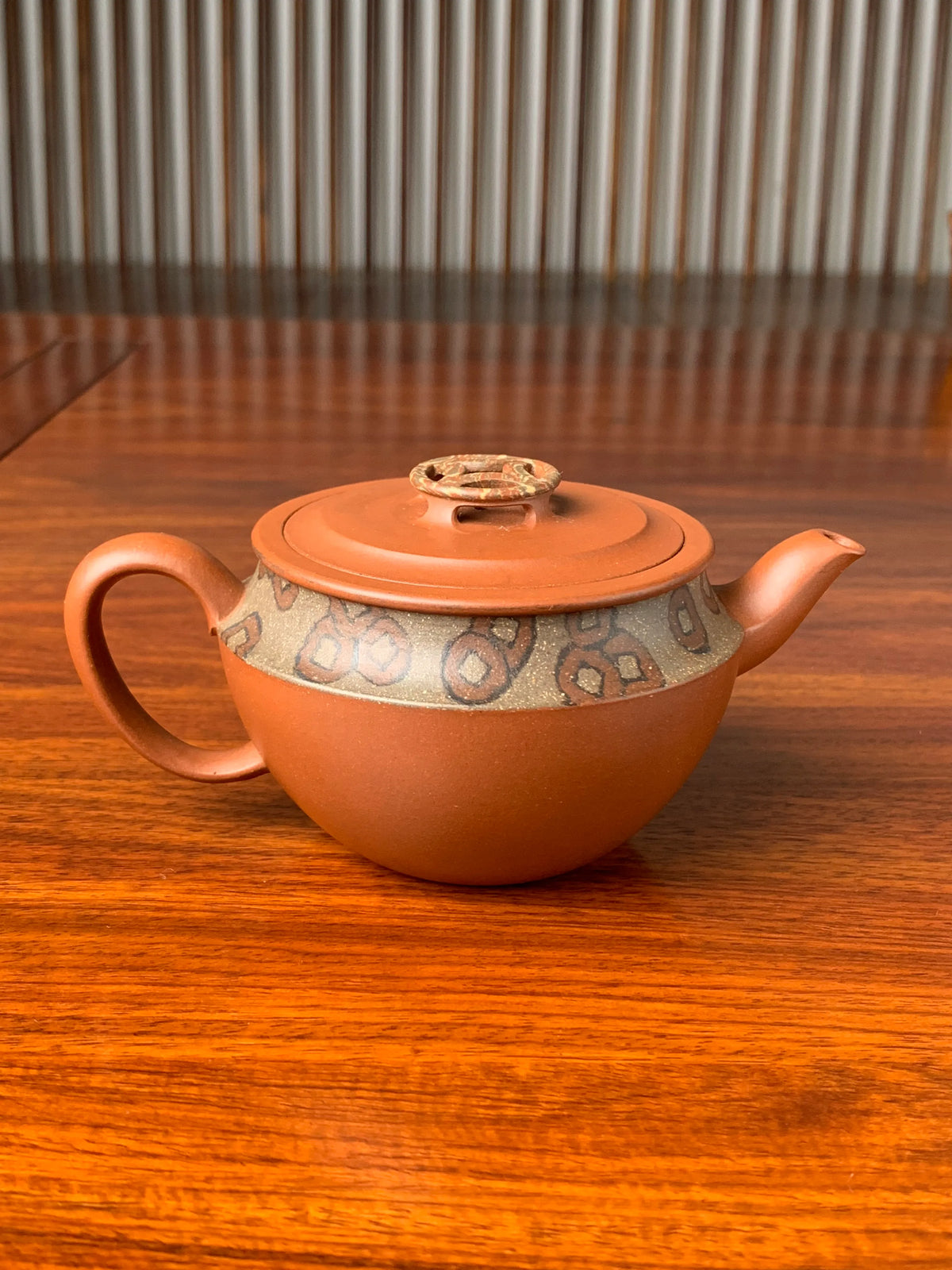 the back view of the yixing zisha clay teapot named bring wealth