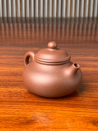 the left view of yixing zisha clay teapot rong tian handmade with zi ni