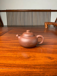 the yixing zisha clay teapot named you de on the table