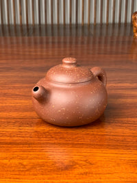 the right view of the yixing zisha clay teapot on the table