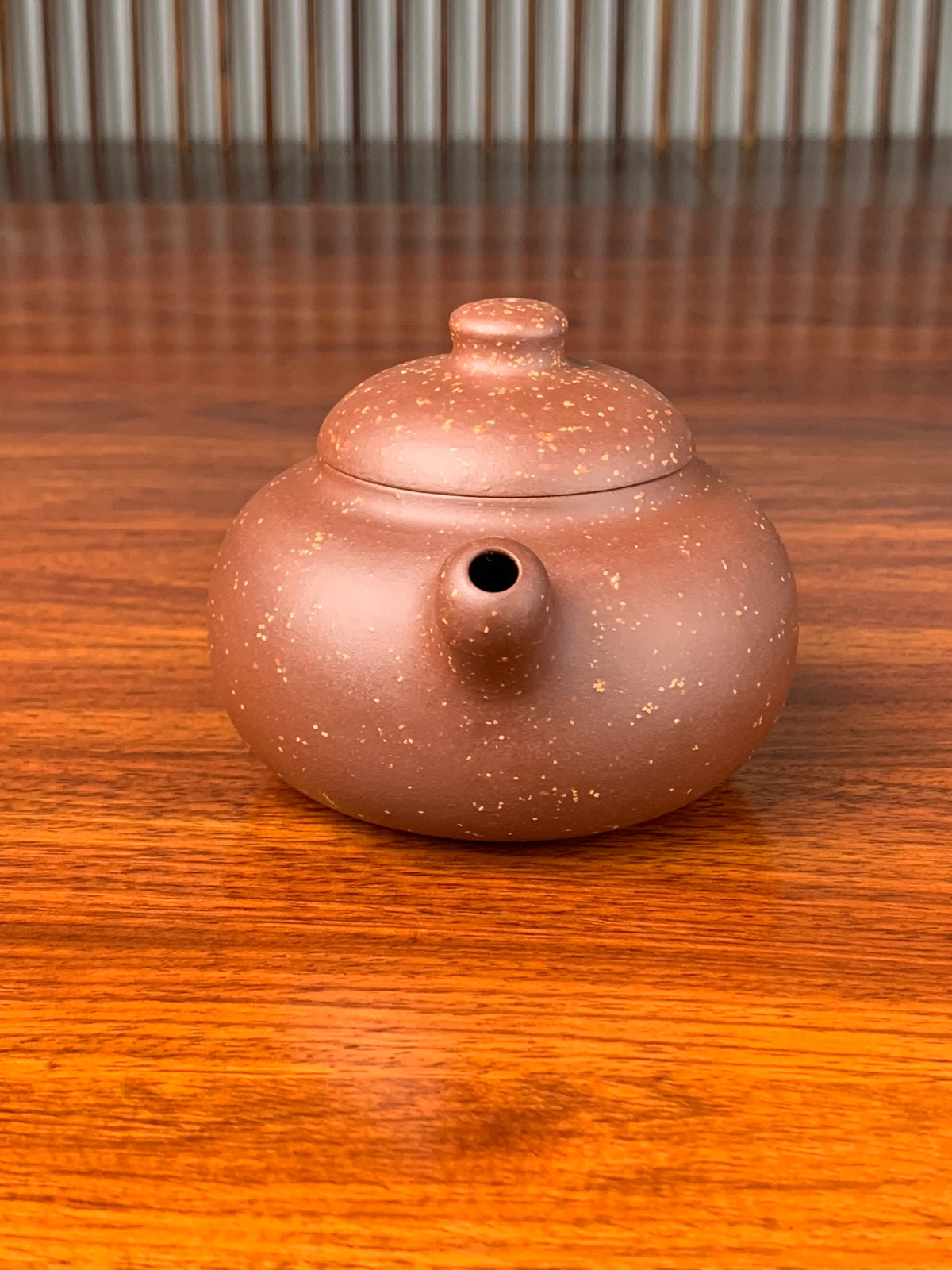 the front view of the yixing zisha clay teapot on the table