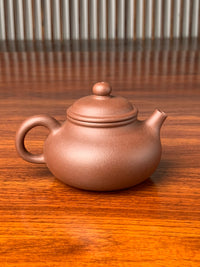 the back view of yixing zisha clay teapot rong tian handmade with zi ni