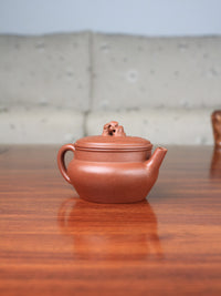 left of yixing zisha teapot handmade by teapot artist