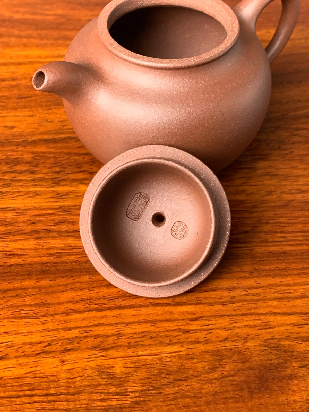 there are two teapot marks of potter tang ziyang in the teapot lid