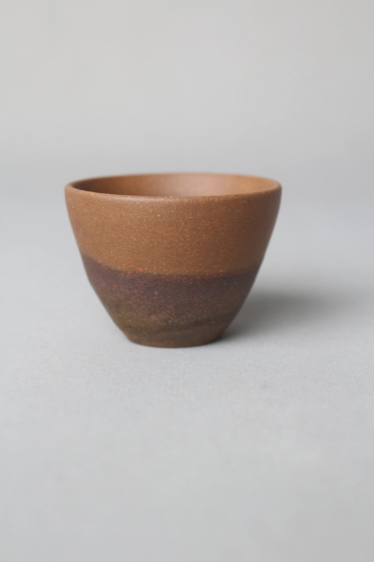 a beautiful zisha teacup is on the table side view