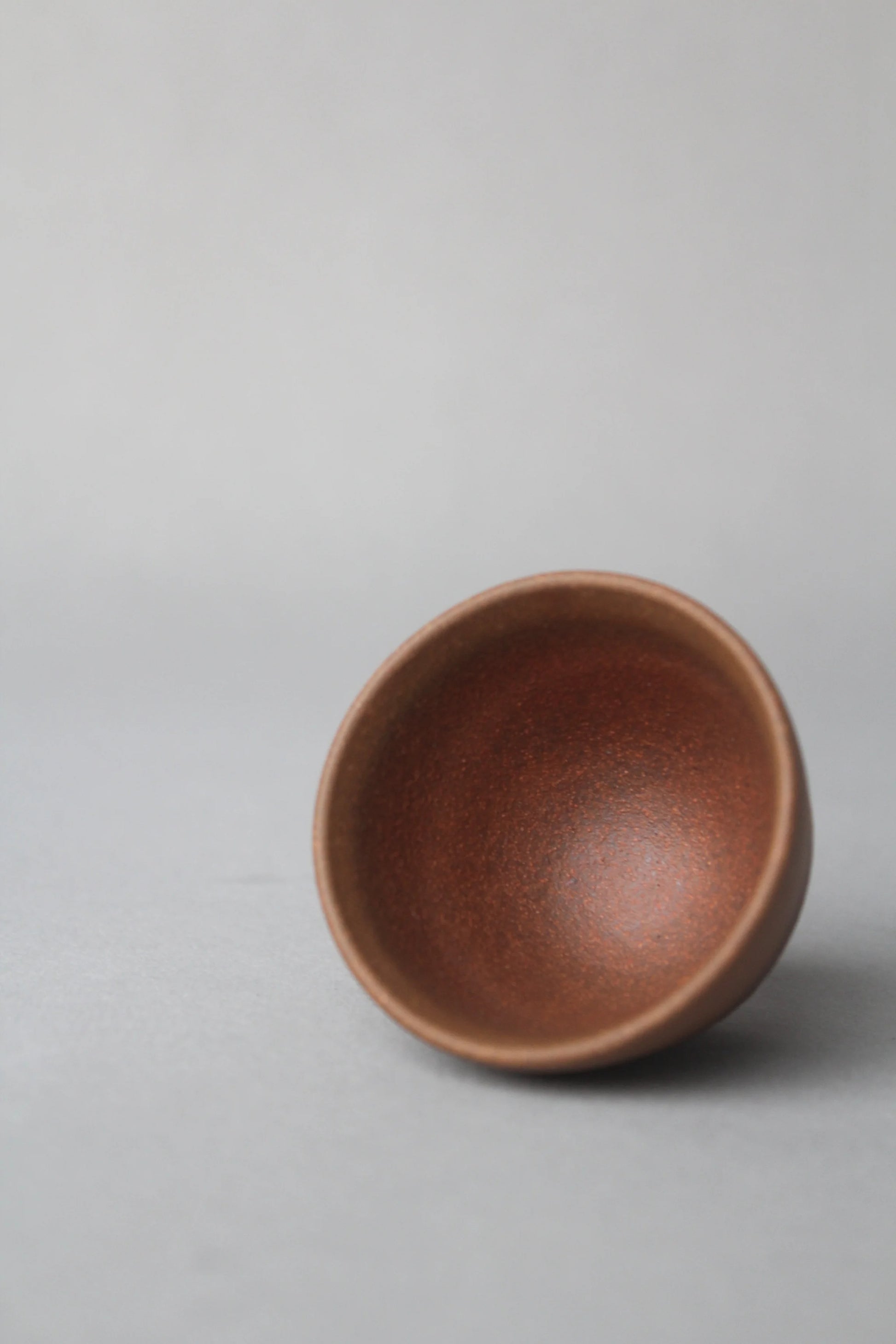 a beautiful zisha teacup is on the table left view