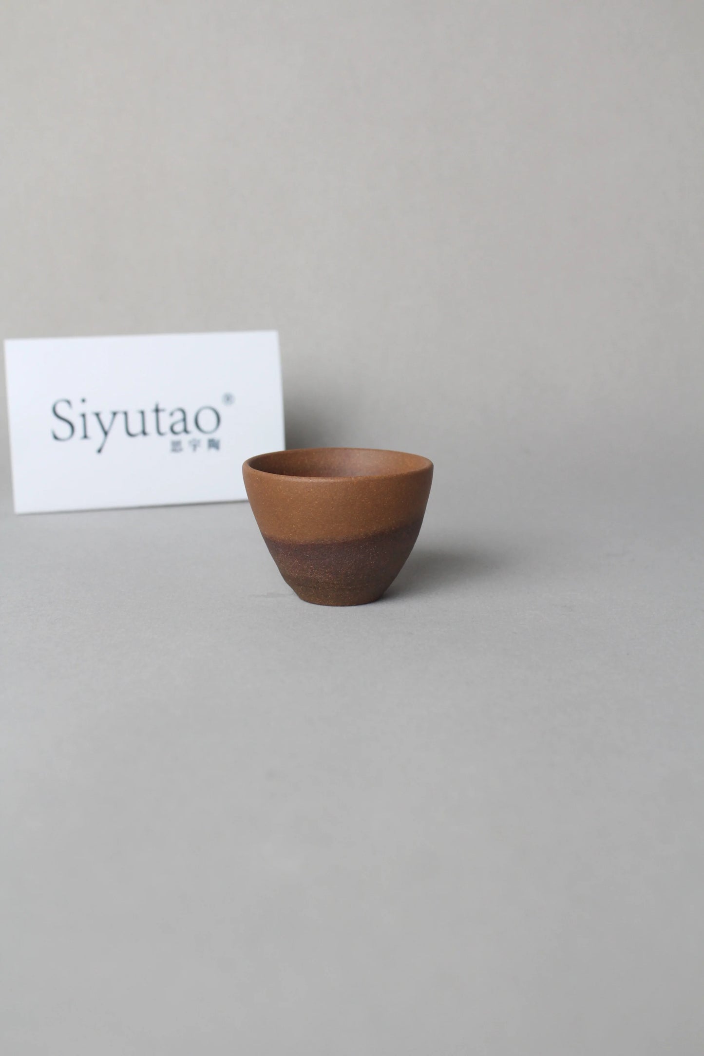 a beautiful zisha teacup is on the table right view