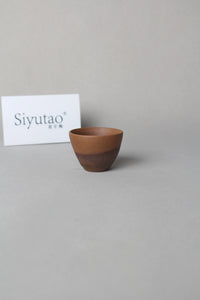 a beautiful zisha teacup is on the table right view