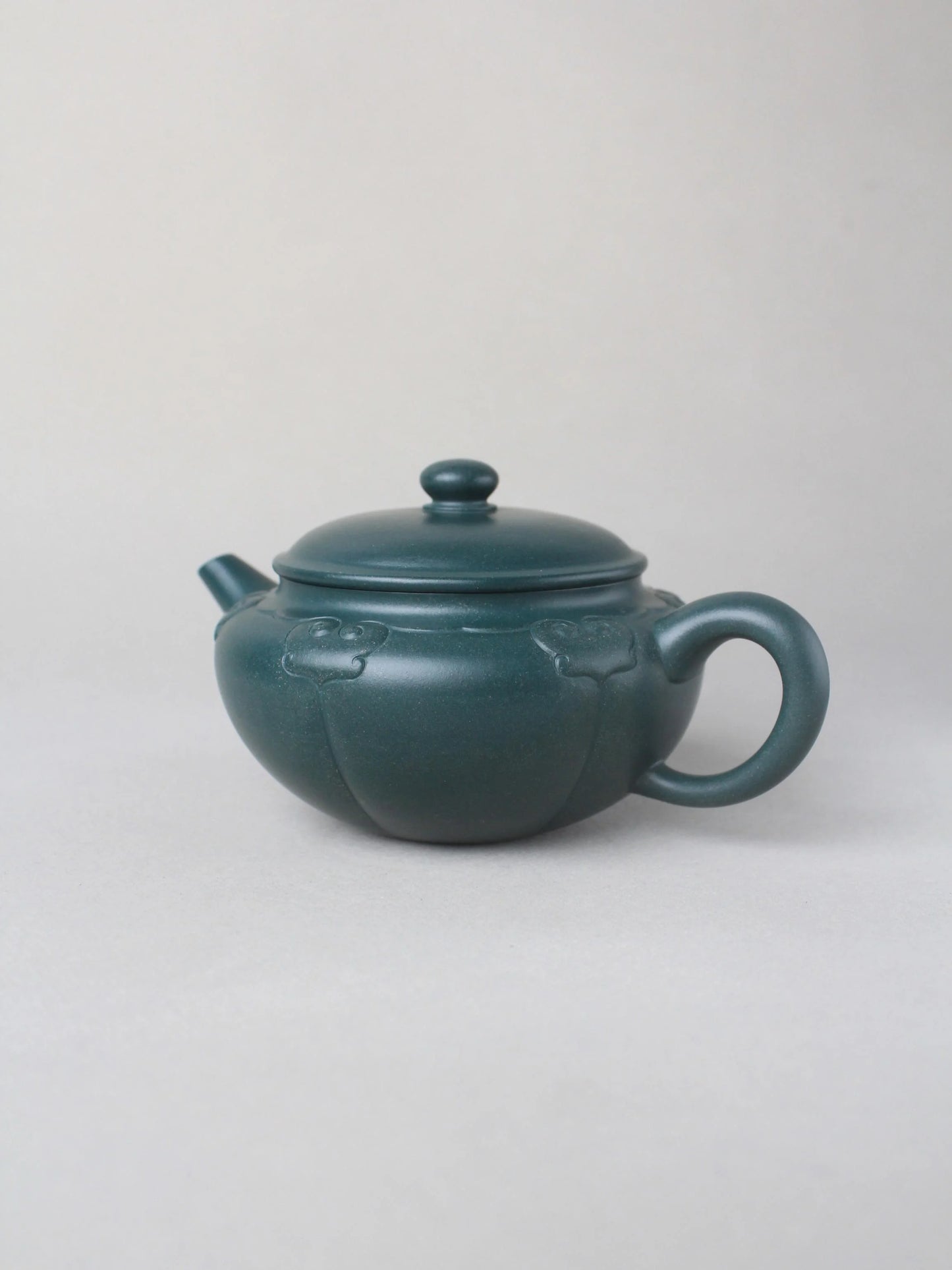 collectible zisha teapot on the table side iew