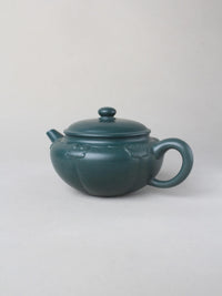 collectible zisha teapot on the table side iew
