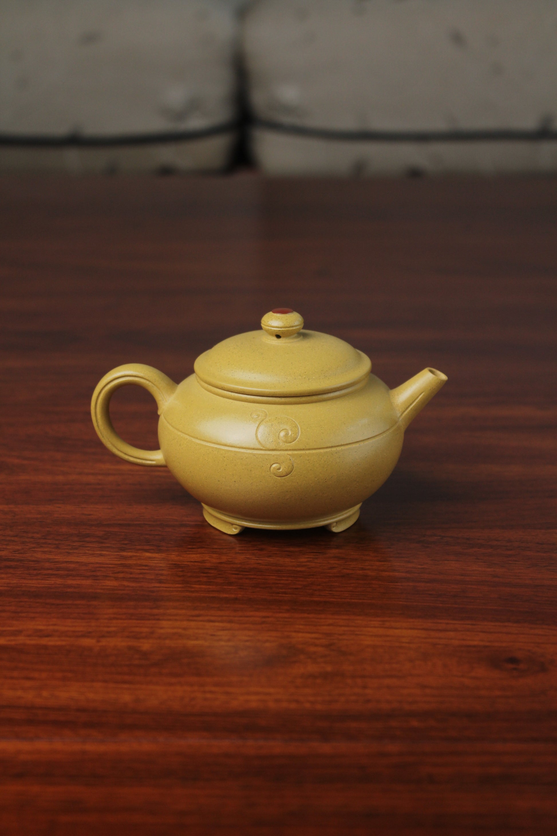 the back of zisha teapot on the table, handmade with purple clay from teapot art zisha art gallery 