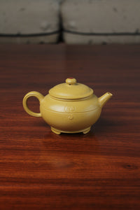 the back of zisha teapot on the table, handmade with purple clay from teapot art zisha art gallery 