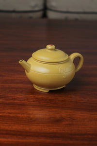 the left of zisha teapot on the table, handmade with purple clay from teapot art zisha art gallery 