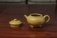 the zisha teapot and lid on the table, handmade with purple clay from teapot art zisha art gallery 