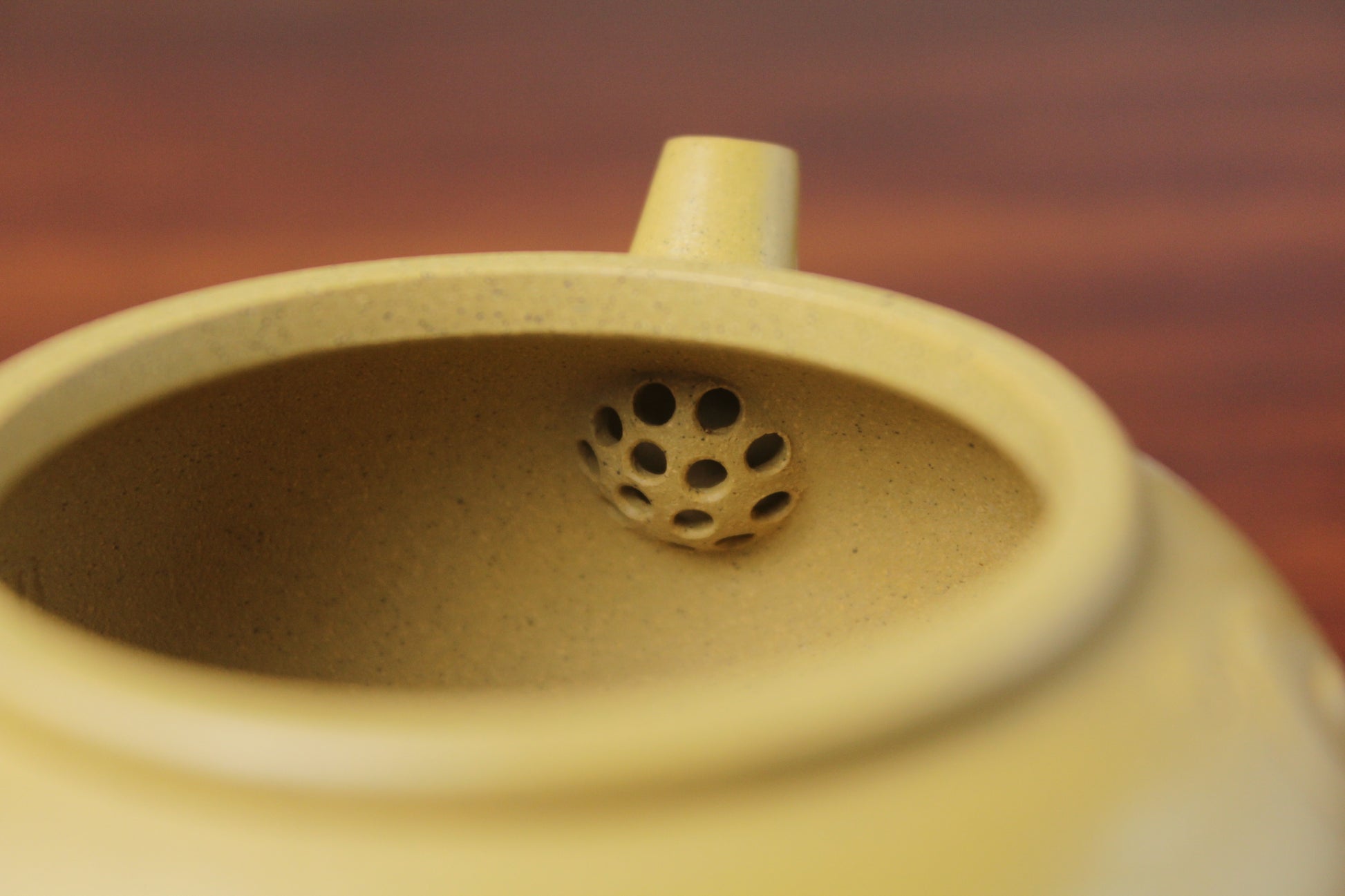 the filter of zisha teapot on the table, handmade with purple clay from teapot art zisha art gallery 