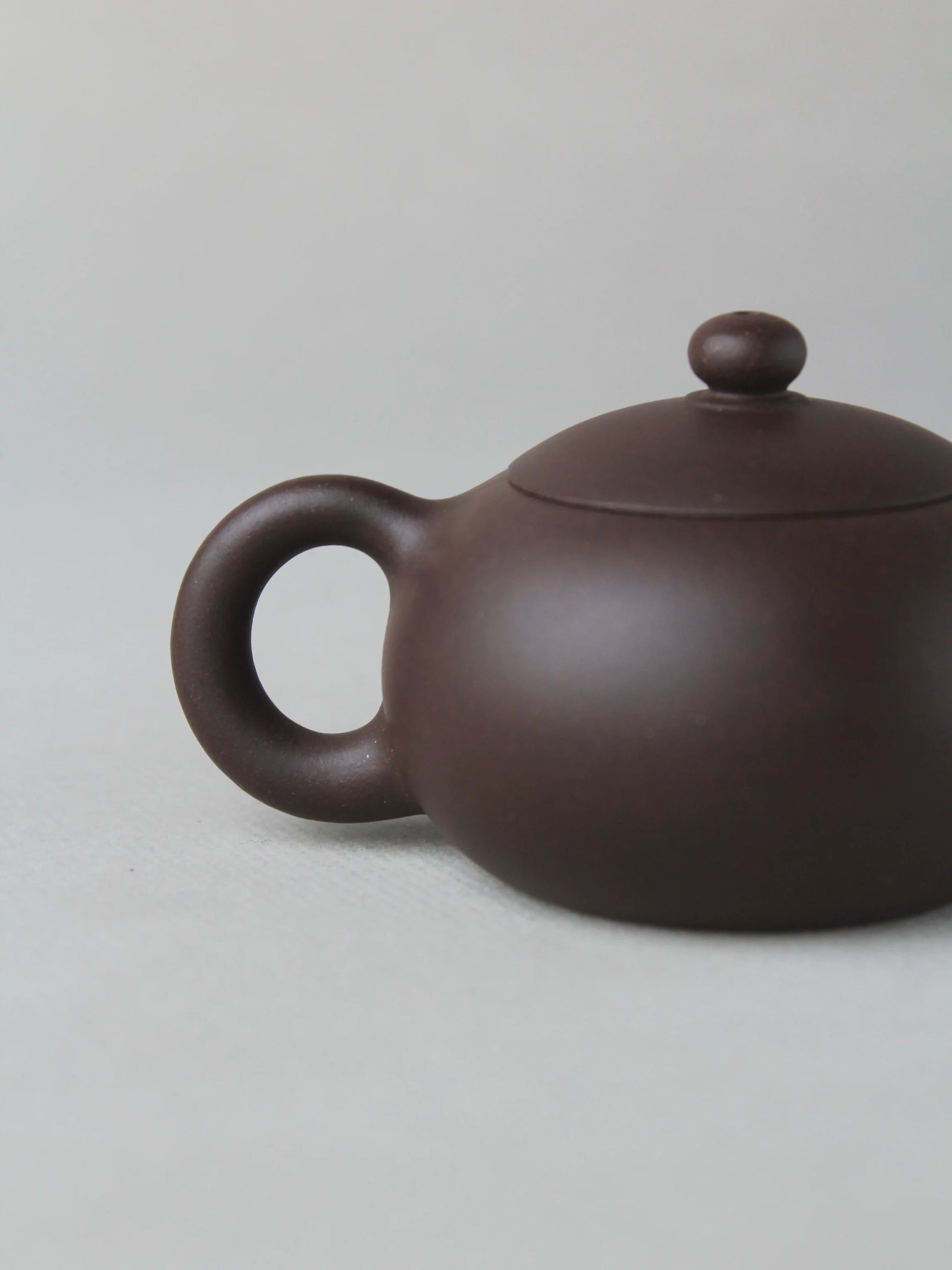 the handle of the small zisha teapot xishi