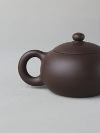 the handle of the small zisha teapot xishi