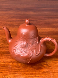 Side view of the lotus sculpture on the teapot body